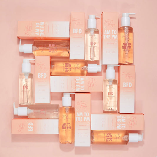 Come Clean Cleansing Duo featuring Fourth Ray Beauty AM to the PM gel cleanser and BFD cleansing oil, pump bottles and peach-and-white boxes arranged in a flat lay on a pastel peach background, a ColourPop Face Cleanser set.