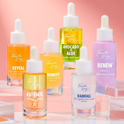 Reveal 10% AHA Serum bottle showcasing its label - orange-tinted glass with a white dropper - standing alongside other Fourth Ray Beauty treatments on clear acrylic risers against a pink gradient; exfoliating ColourPop Face Serum.