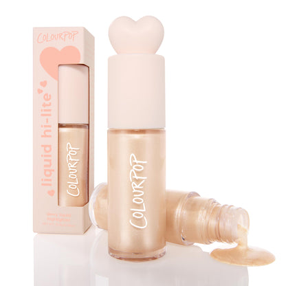 ColourPop Liquid Highlighter Sugar Donut bottle stands capped with a blush heart-shaped top, while an open vial pours dewy pearly champagne glow; a peach box labeled liquid hi-lite sits behind on a white studio background.